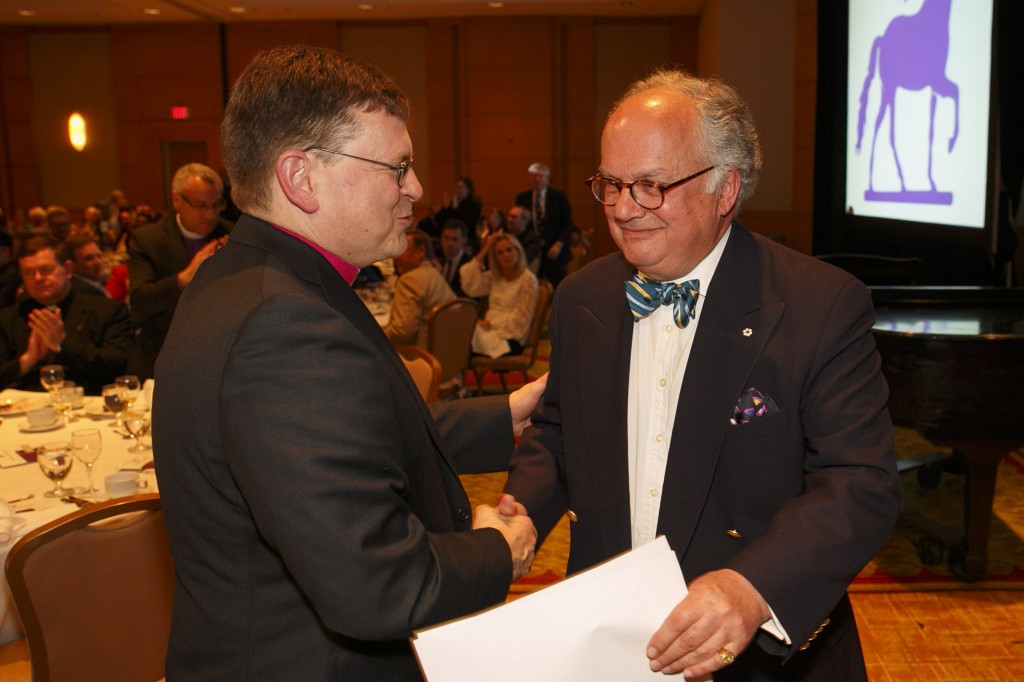 People applaud John Fraser, author and journalist, at the Bishop's Company Annual Dinner at the Marriott Downtown Toronto Eaton Centre, Tuesday, May 20, 2014. Photo/Michael Hudson