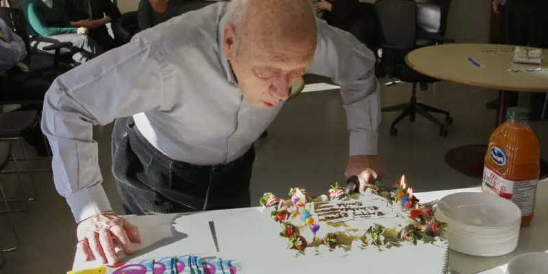 David Ptolemy blows out the candles on his cake