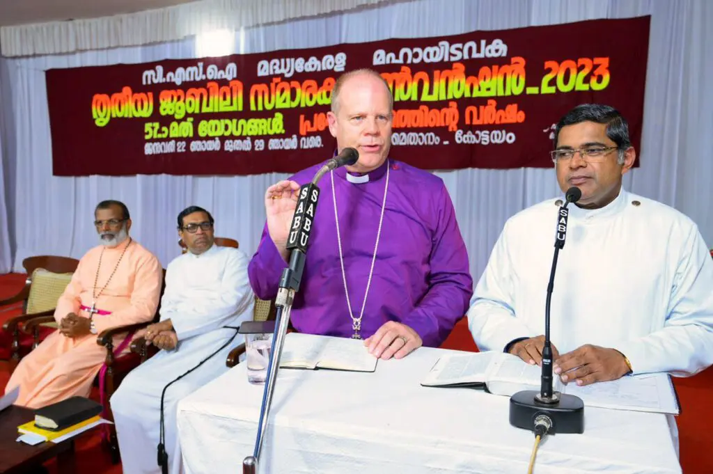 Bishop Andrew speaks at a lectern