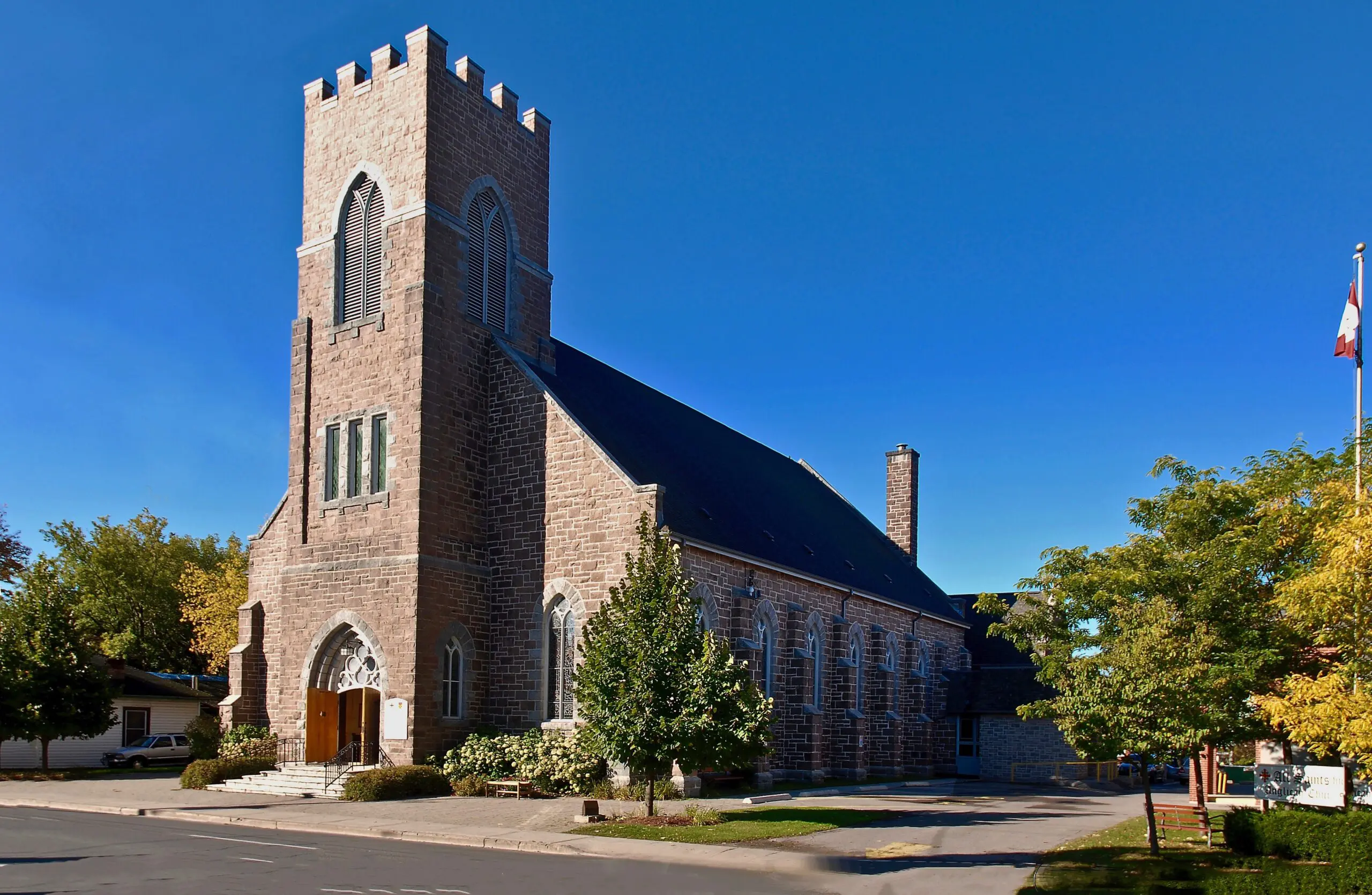 A stone church with square tower.