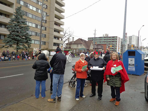 Folks from St. David, Lawrence Avenue, hand out hot chocolate and flyers for the upcoming Christmas/Advent Season