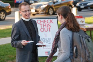 Anglican priests hand out Back To Church Sunday invitations, Toronto, Canada.