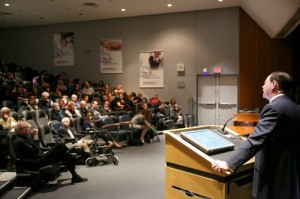 An audience of about 200 listens to Mr. Solomon at Mt. Sinai Hospital. 