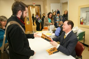 After his talk, Mr. Solomon signs copies of his book. 