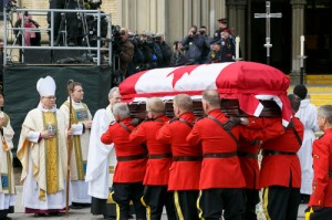 Mounties carry Mr. Flaherty's coffin into St. James Cathedral in Toronto. At left is Archbishop Colin Johnson, who presided at the state funeral. Photo by Michael Hudson