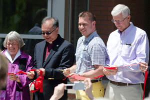 Councillor Pam McConnell, Bishop Patrick Yu, deputy people’s warden John van Gent and parishioner Doug Milloy cut the ribbon at the official opening of Little Trinity’s restored properties at 399-403 King Street East on May 25. Photo by Andrea D'Silva.