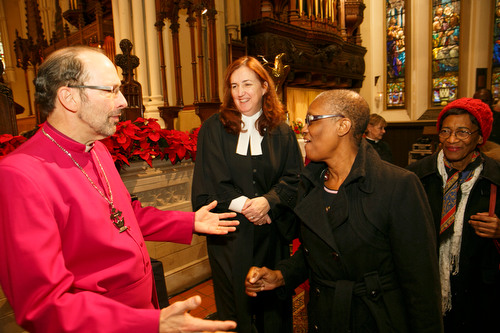 Bishop Philip Poole greets friends as Chancellor Clare Burns looks on. 