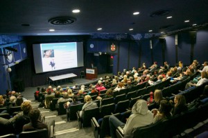 Guests watch a video of Dr. Donald Low. 