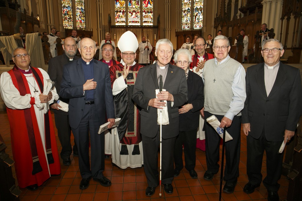 Clergy receive their Golden Jubilee stoles from the Archbishop.