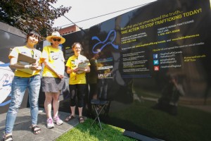 From left, Justine Lee, Leah Watkiss and Kristin Strong of Faith Alliance to End Human Trafficking, stand the GIFT Box. 