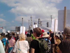 Protestors on the Toxic Tour walk beside smokestacks across from the Aamjiwnaang First Nation Reserve near Sarnia.