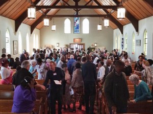 The passing of the peace at the inaugural service.