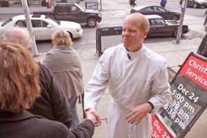 The Rev. Canon Andrew Asbil greets people outside Church of the Redeemer.