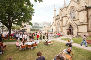 People attend a barbecue on the lawn of St. James' Cathedral on Canada Day in 2012
