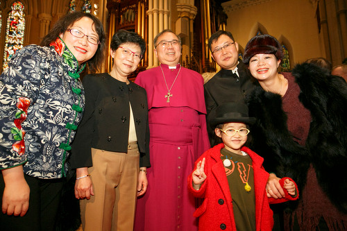 Bishop Patrick and Cathy Yu greet Morning Wang (left) and James Liu and his family. 