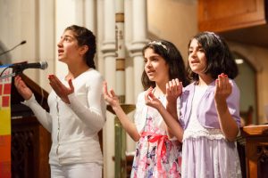 Diala, Slava and Rouhayef Brimo sing a song they have written thanking Jesus. 