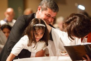 Bachir Brimo holds his youngest daughter as she is baptized by the Rev. Canon Jenny Andison at St. Clement, Eglinton. Photos by Michael Hudson 