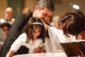 Bachir Brimo holds his youngest daughter as she is baptized by the Rev. Canon Jenny Andison at St. Clement, Eglinton. Photos by Michael Hudson