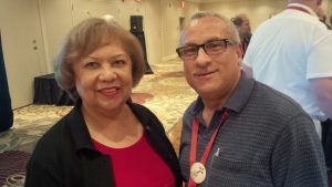 Organizer Andrea Delvaille and Bishop Peter Fenty enjoy the diocese's reception at General Synod. Photo by Stuart Mann