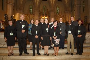 The 12 episcopal nominees stand on the chancel steps.