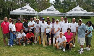 A group of cricket players poses for a photo in a Mississauga park.