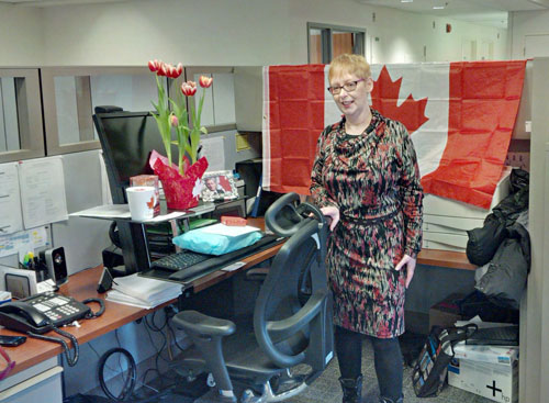 Gina at her workstation, returning to an awesome welcome as a new Canadian!