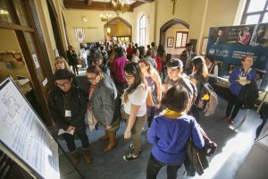 People mingle, chat, get coffee and browse displays during a break.