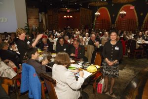 Kathy Yu stands as guests applaud her.